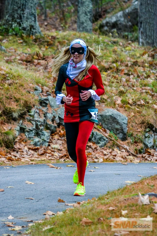 a women in red jacket and head scarf running