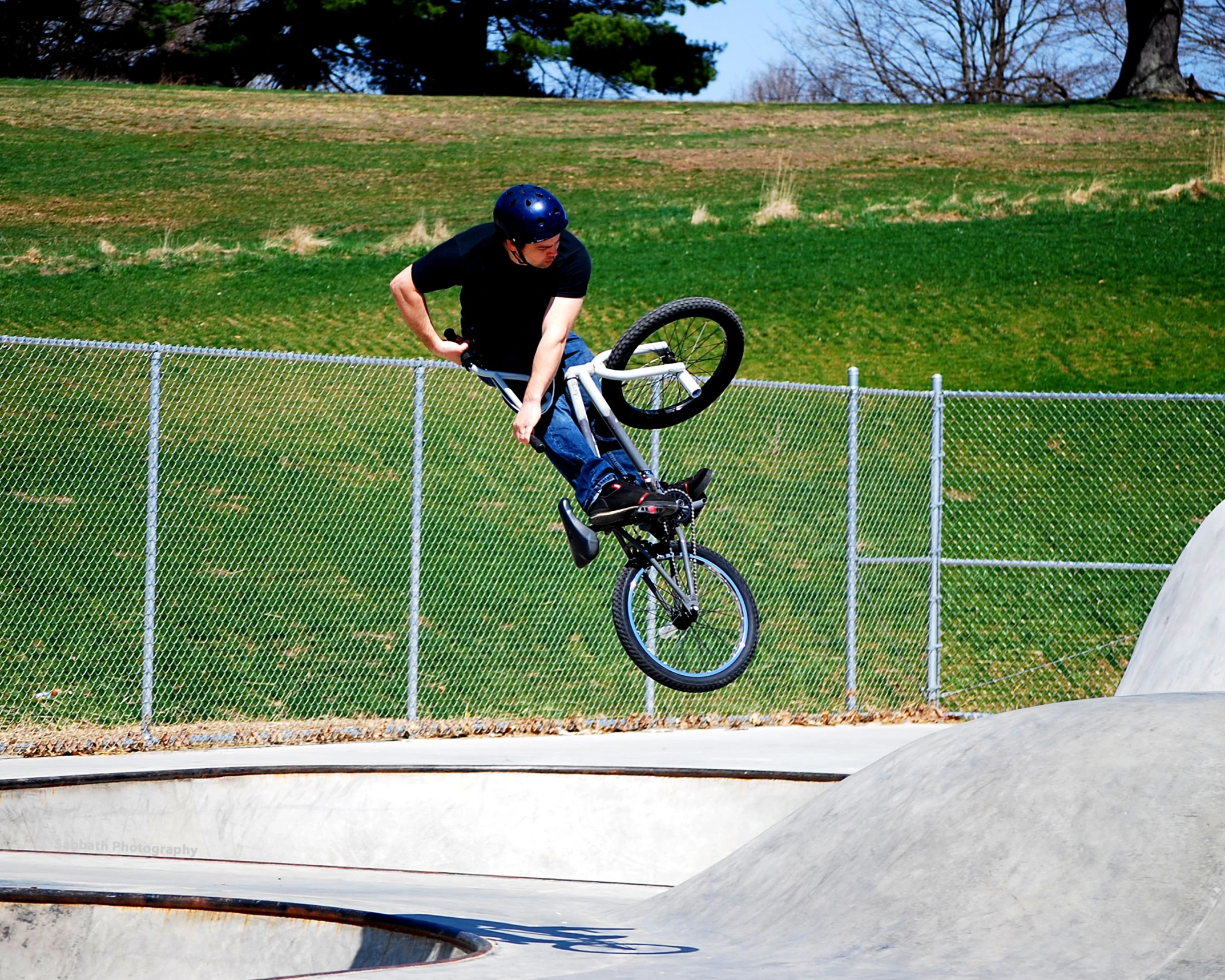 a man jumping with his bike over a ramp