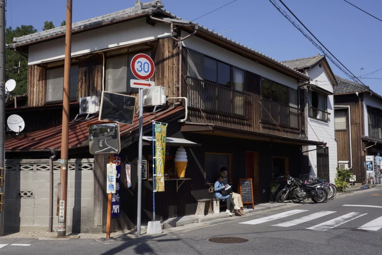 a small three story building with an interesting sign