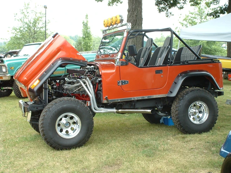 an orange truck with its wheels turned back