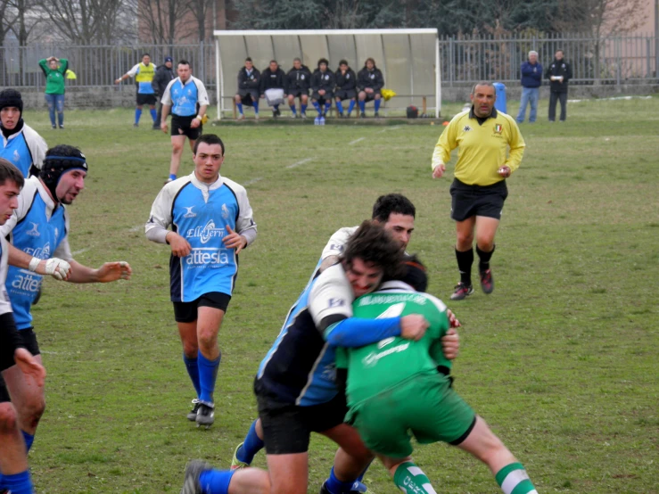 a group of soccer players play a game of rugby