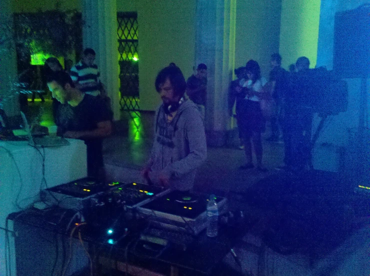 a dj mixes up some music for a group of people