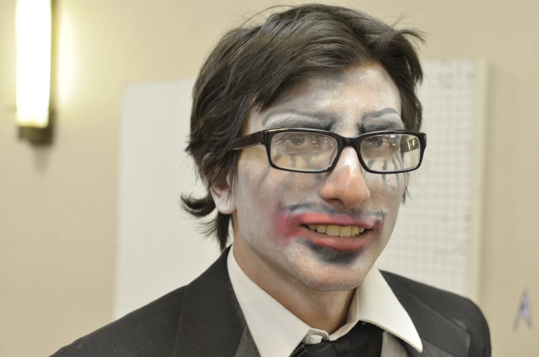 a man in a suite has face paint painted on his face