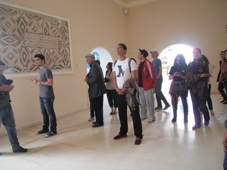 a group of people standing next to each other in front of a doorway