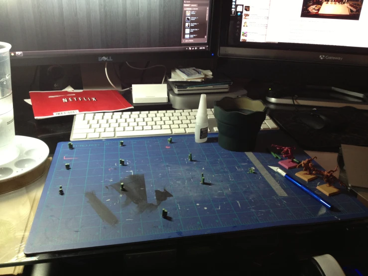 a desk that has a keyboard, mouse and various legos on it