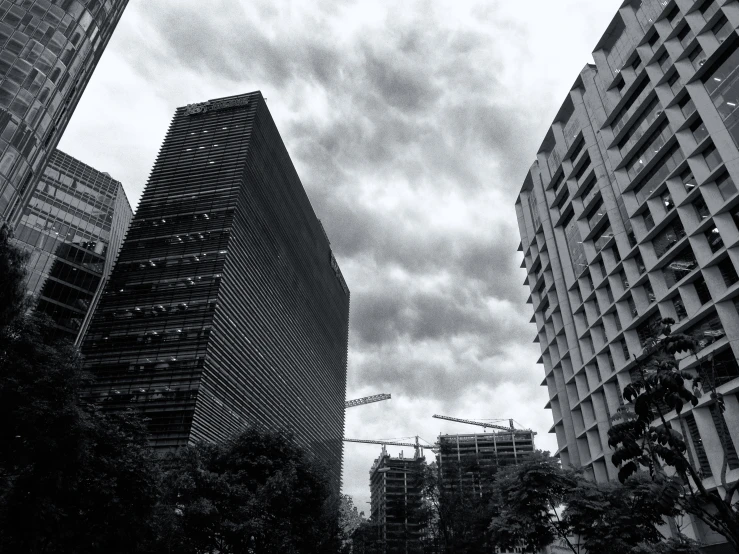 a group of buildings with dark clouds in the background