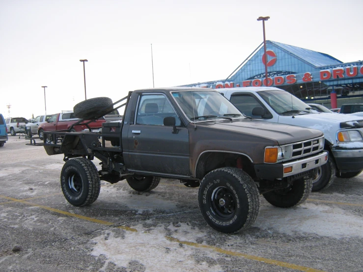 a car parked on a parking lot next to other cars