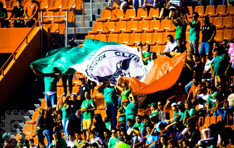 a view of a person standing on a stand with a mexican flag