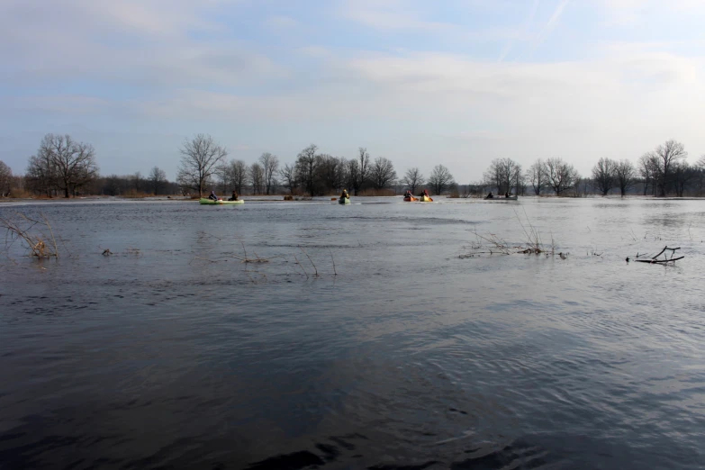 several small boats sitting in the middle of a river