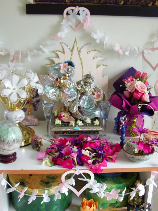 several vases sitting on a table with various items