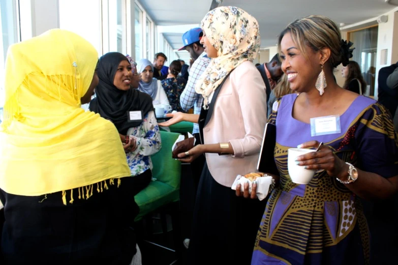 a group of women gathered around each other with food