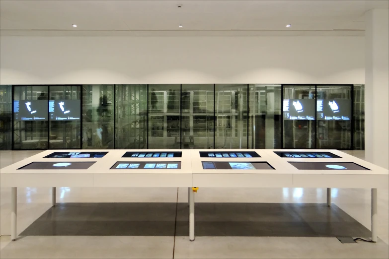 a table filled with electronic devices in a room