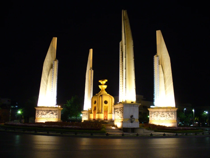 a monument at night surrounded by many lights