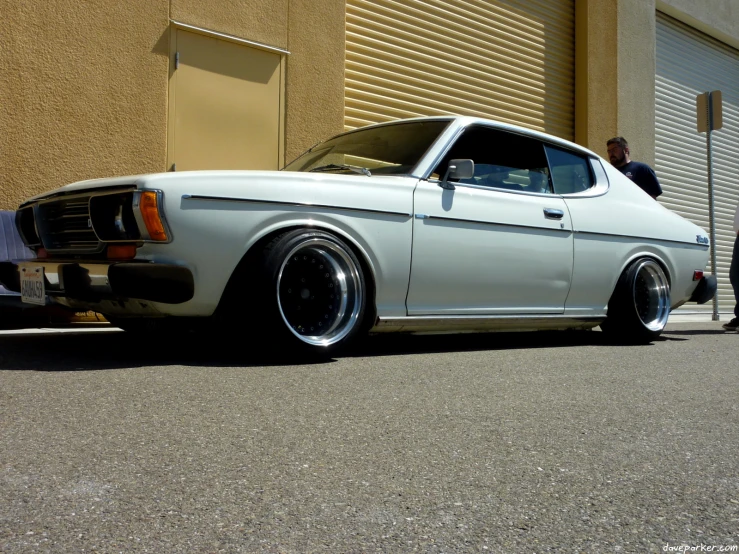 a white car parked next to some tall buildings