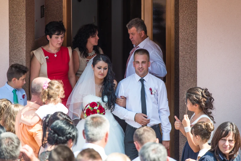 a bride and groom entering a house at their wedding