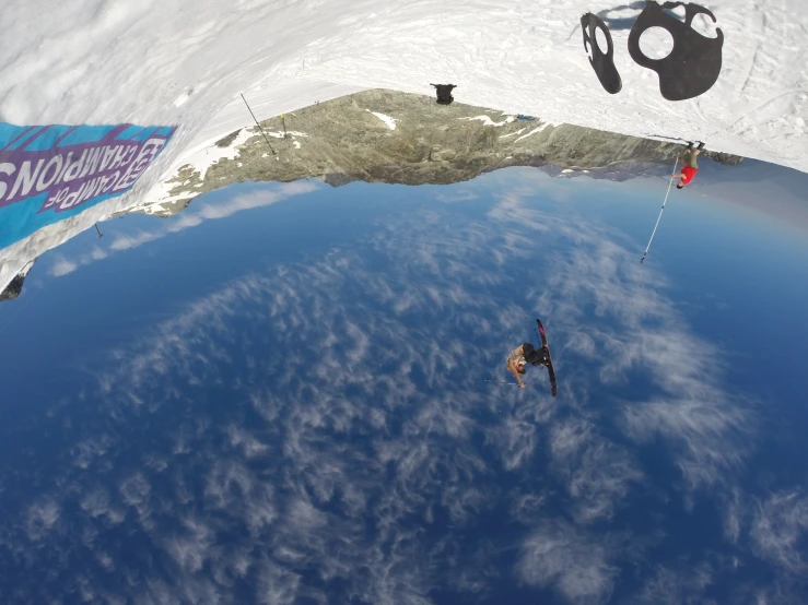 the snowboarder is airborne in his trick on the slope