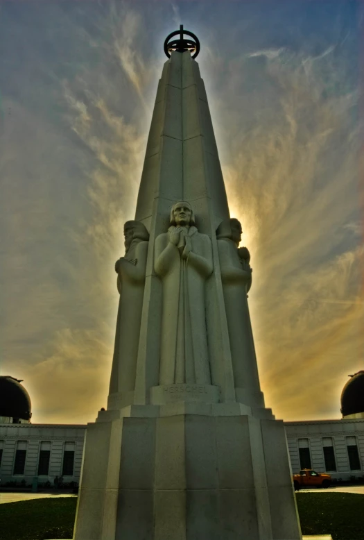 a very tall building with a very small statue on the side of it