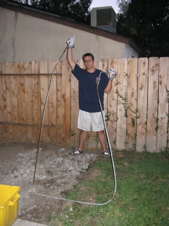a man is watering the yard with a high pressure water hose