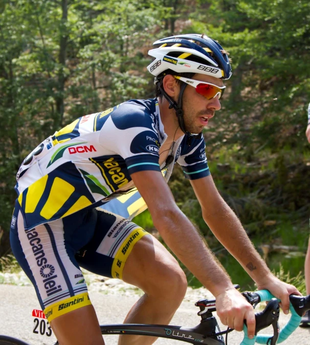 a man in blue and yellow cycling outfit