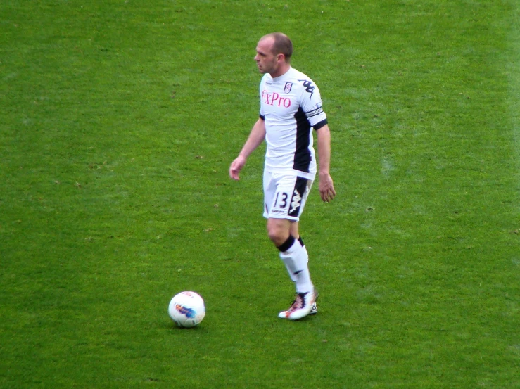 man on soccer field preparing to kick the ball