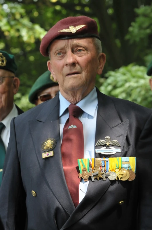 the men are wearing uniforms and military medals