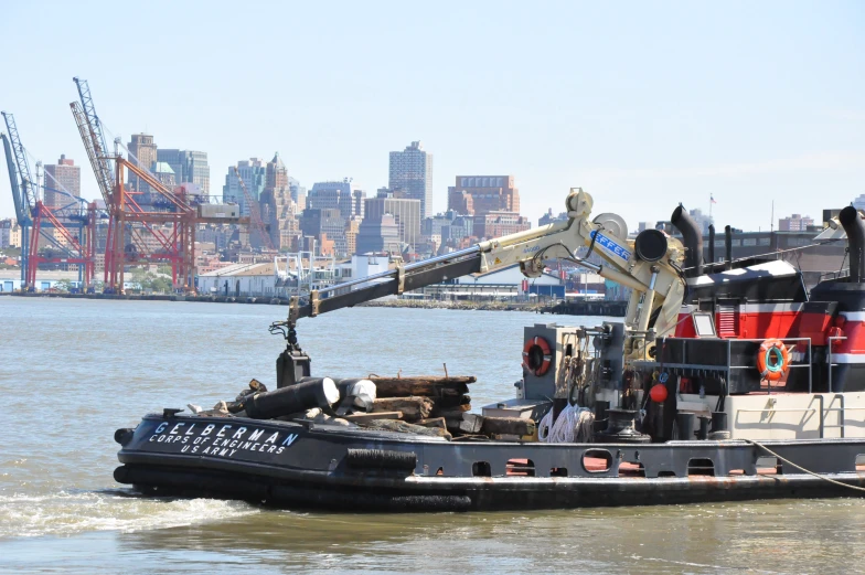 a small boat is in the water by a city