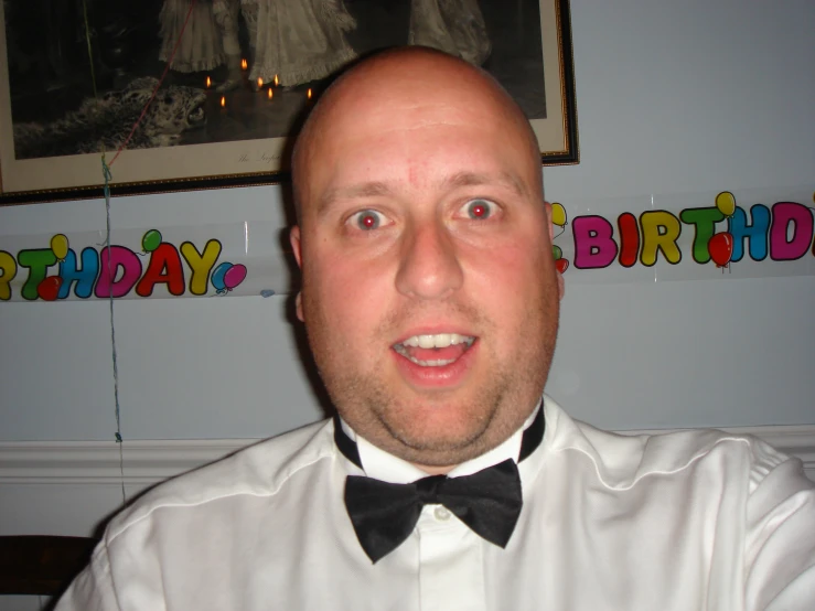 an image of a man in a tuxedo looking surprised
