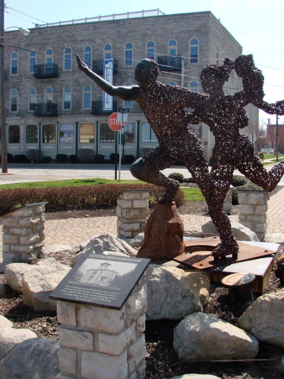 a statue of a boy dancing outdoors on the street