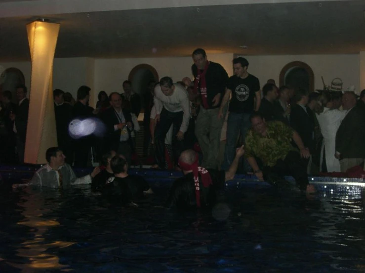 a large group of people gathered together in a pool