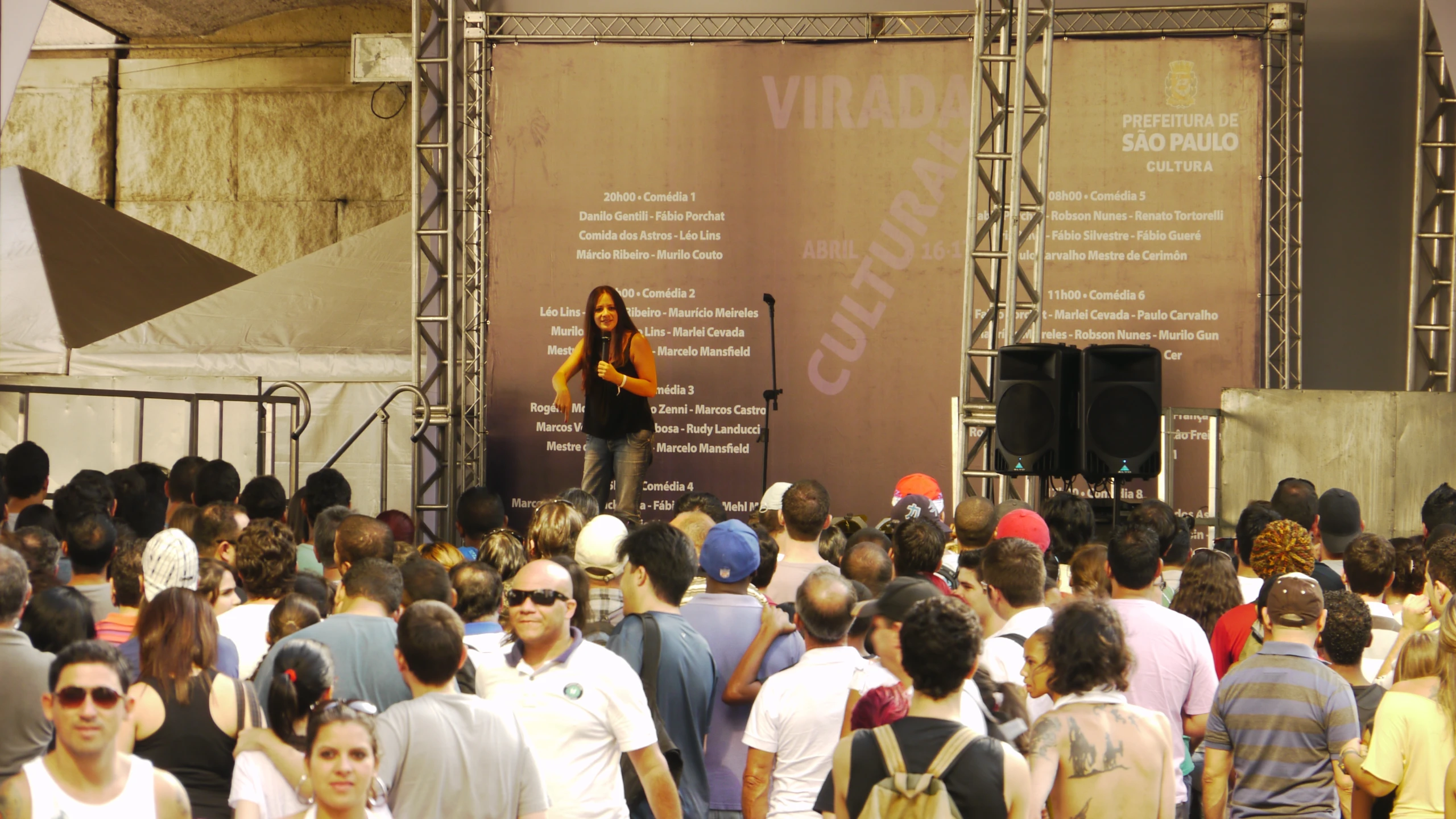 woman standing at a podium with an audience