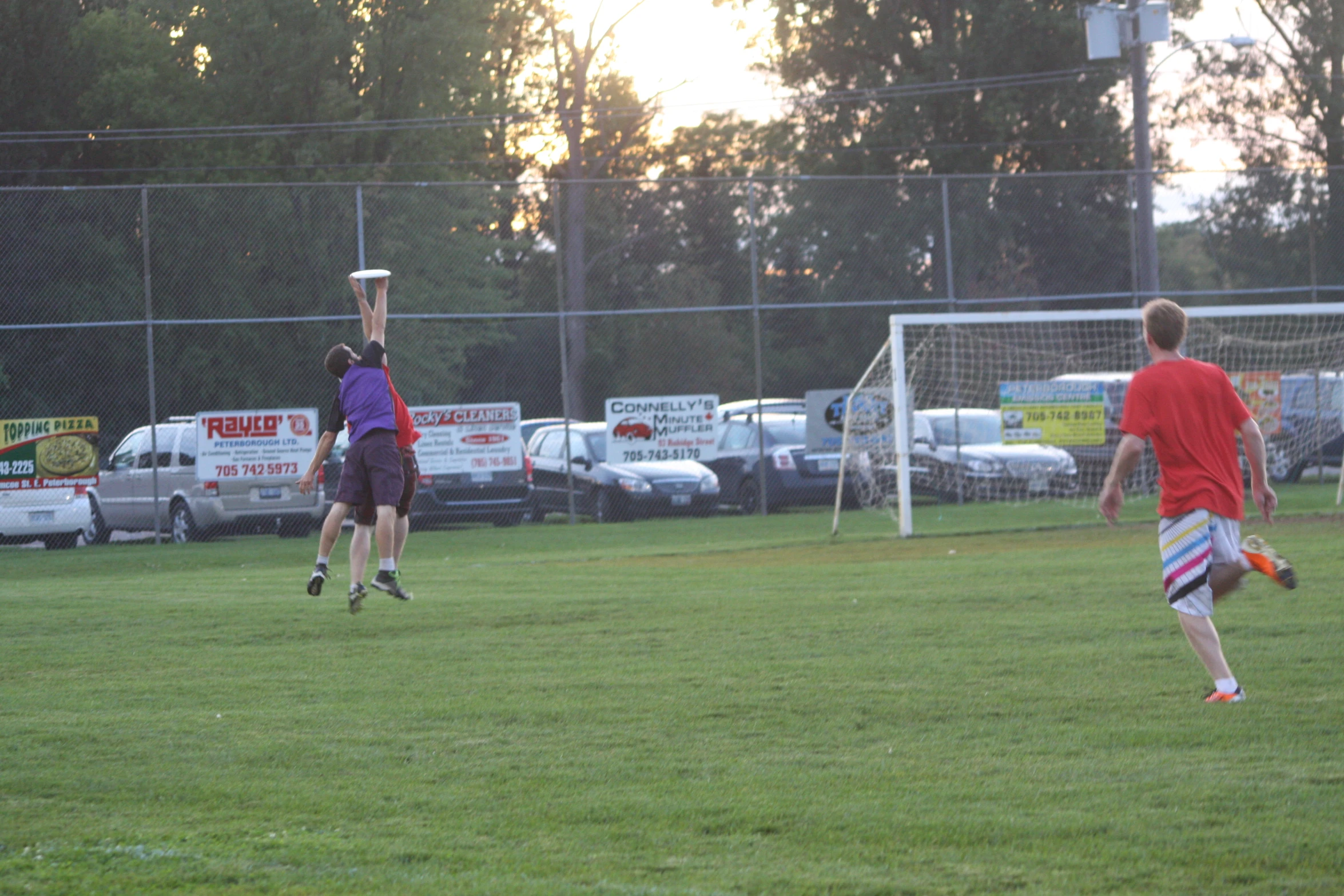 a group of young men playing a game of frisbee