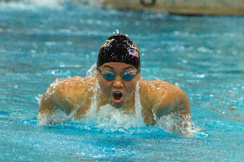 swimmer about to swim through water in a swimming pool