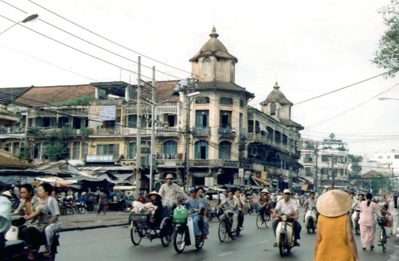 a group of people riding bicycles in the street