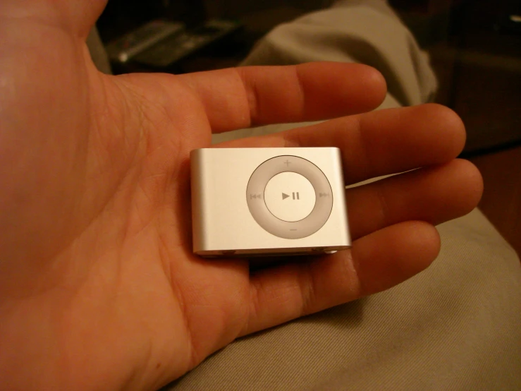 a hand holding an ipod in the palm