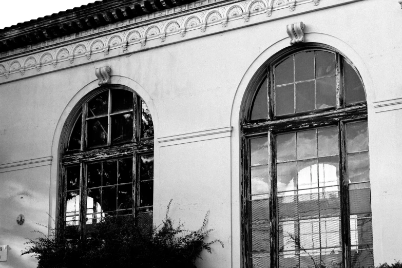 black and white image of a building with arched windows