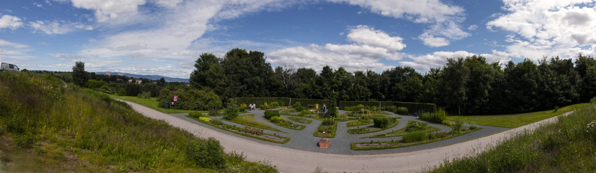 a view from the top of a hill of an ornamental maze