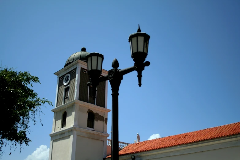 a large clock tower with a street light at the top