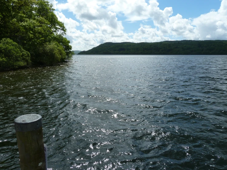 water with sun shining onto the water and a dock