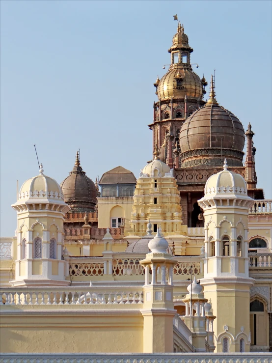 a golden, ornate building with a clock on the roof