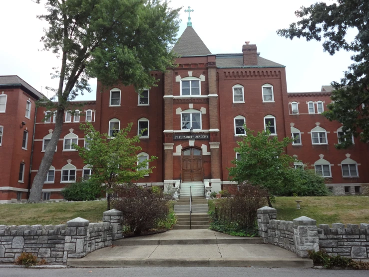 this old brick school has a very big gate