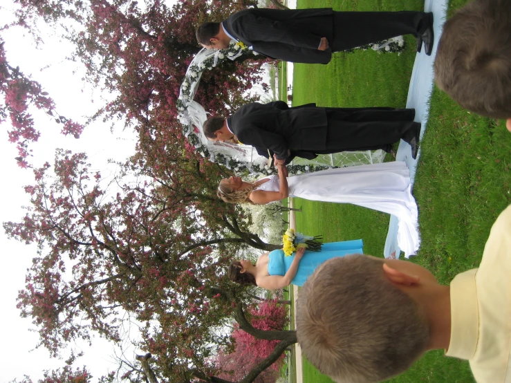 a wedding ceremony with a bride and groom at an outdoor alter