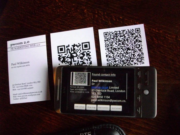 some black and white business cards on a brown table