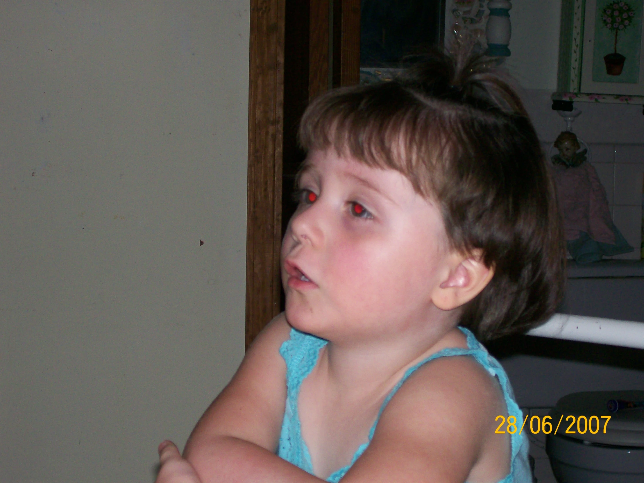 a toddler looking at soing on her hand