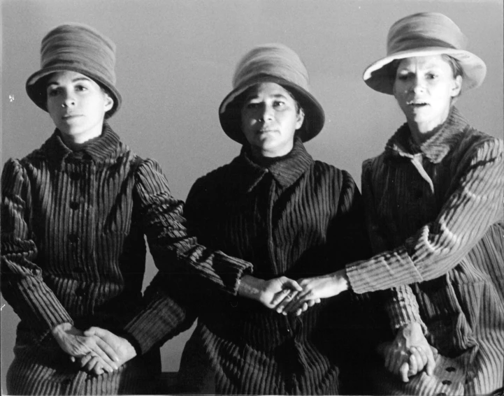 three young women in hats standing next to each other