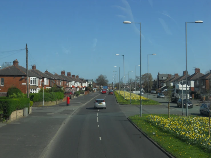 a street filled with traffic next to houses