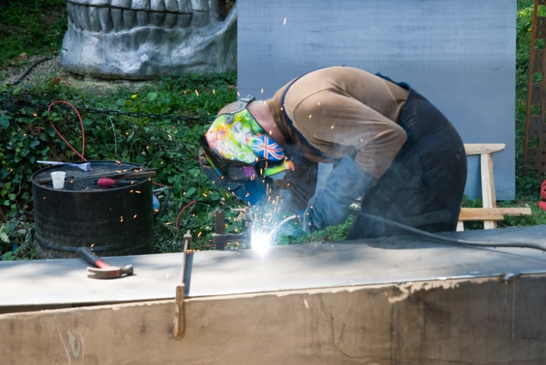 a man grinding cement with an angle grind