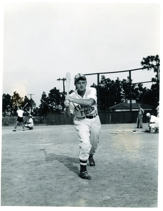 black and white po of baseball player holding a bat