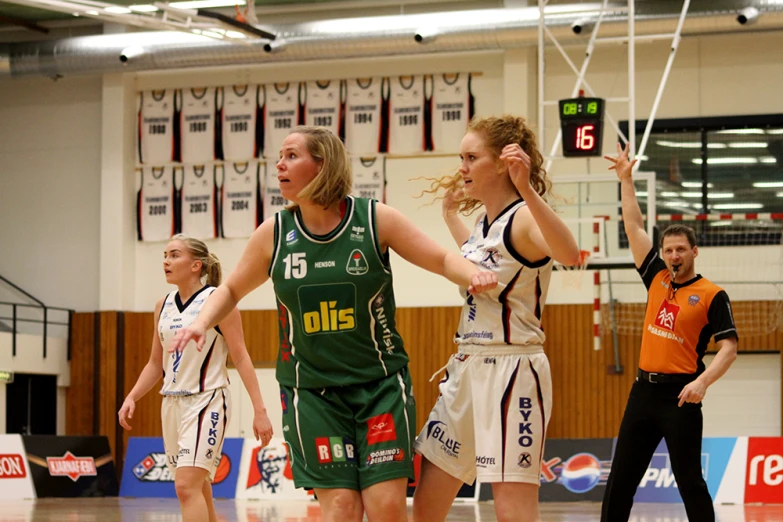 a group of women playing basketball on a court