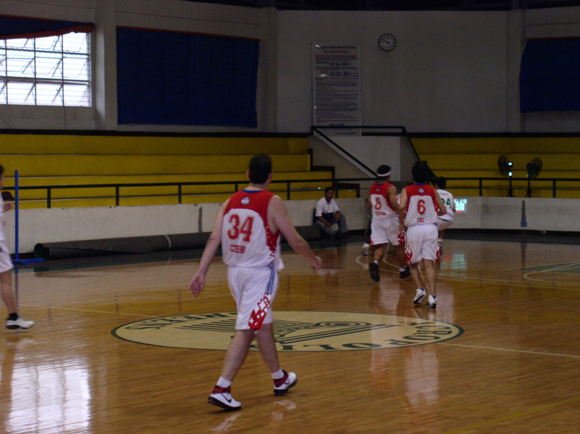 there is a men's basketball team playing in the gym