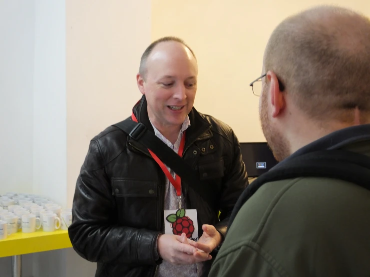 two men talking at an event, with each other